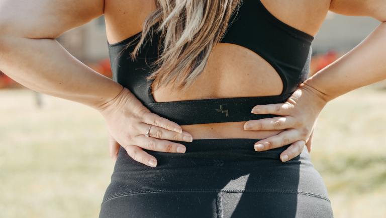 a woman with her hands on her hips.